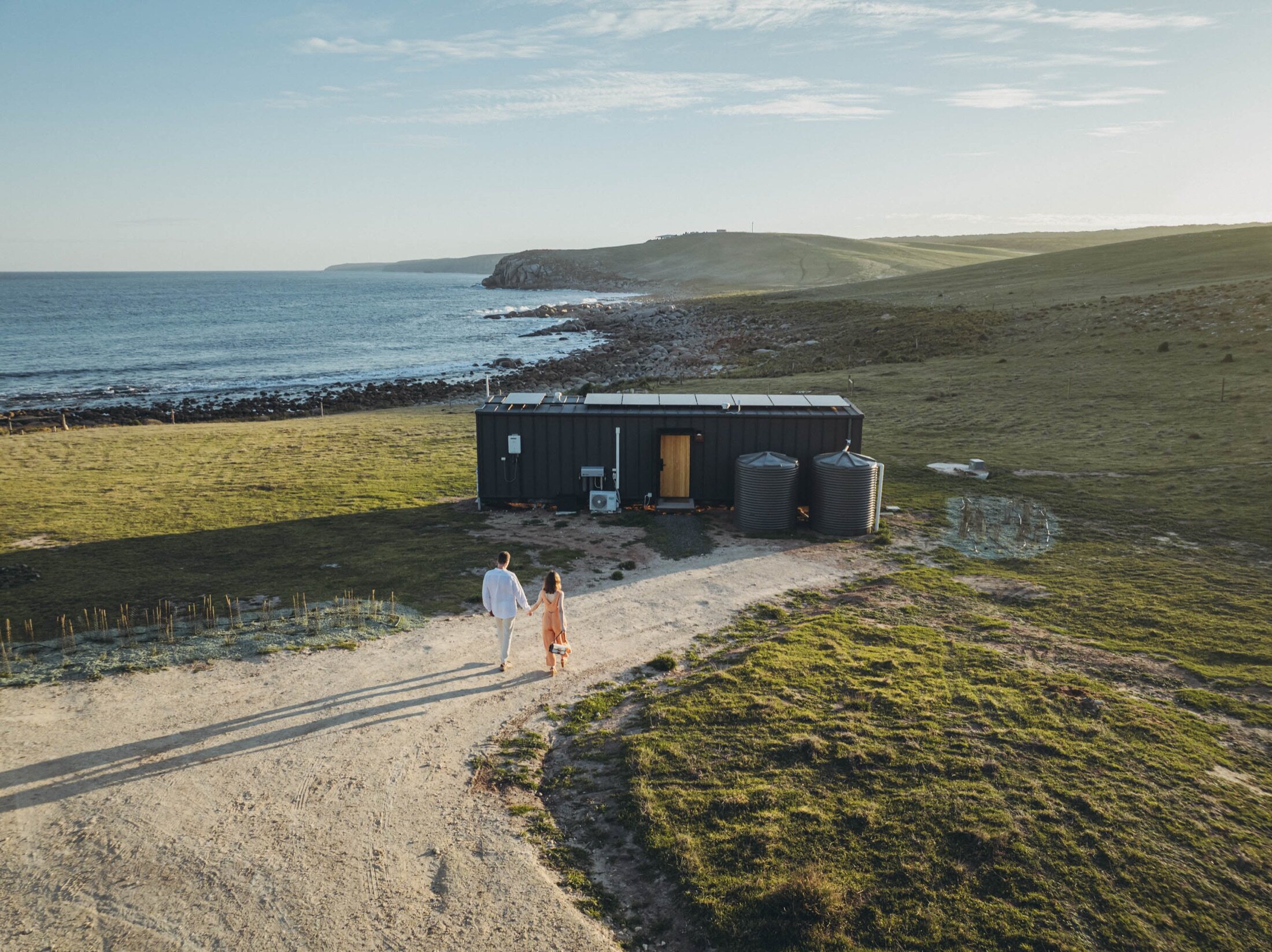 An AUTRA cabin on the wild Kangaroo Island coast at golden hour